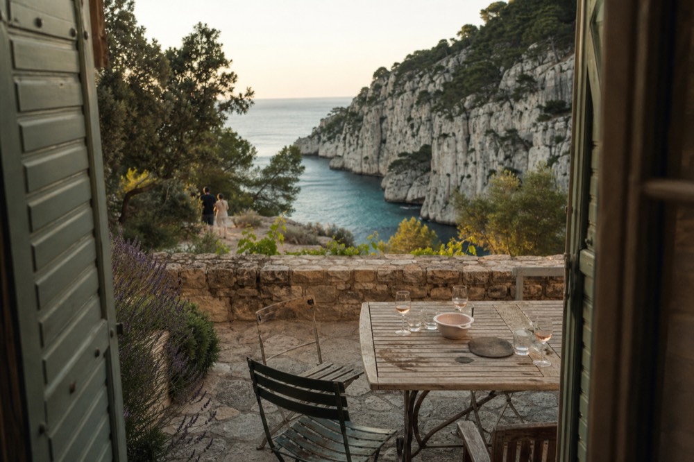 A stone wine estate terrace above the turquoise Mediterranean near Cassis, no text, no logos, no people