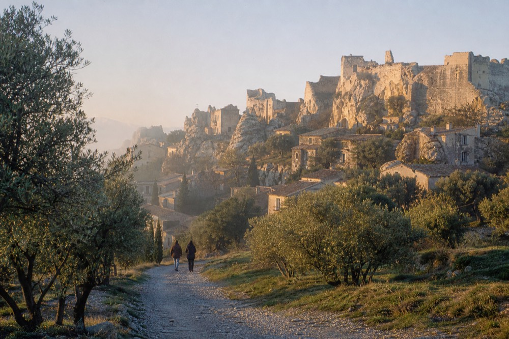 Hilltop village of Les Baux-de-Provence with olive trees and limestone outcrops, no text, no logos, no people