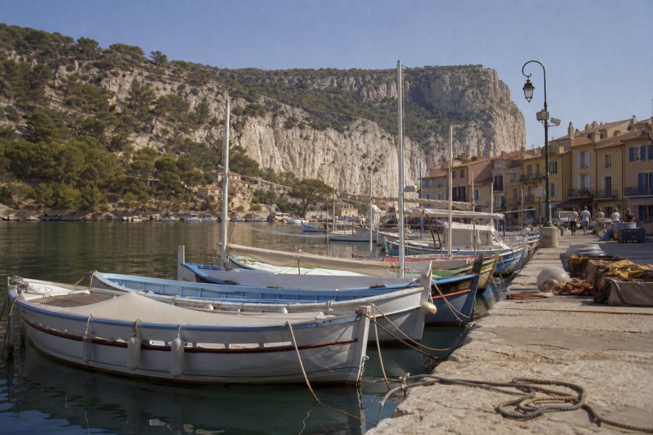 The harbour of Cassis with boats and cliffs behind, no text, no logos, no people