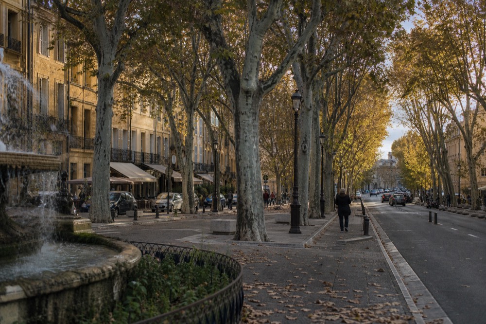 Narrow golden-stone street in the old town of Aix-en-Provence, no text, no logos, no people